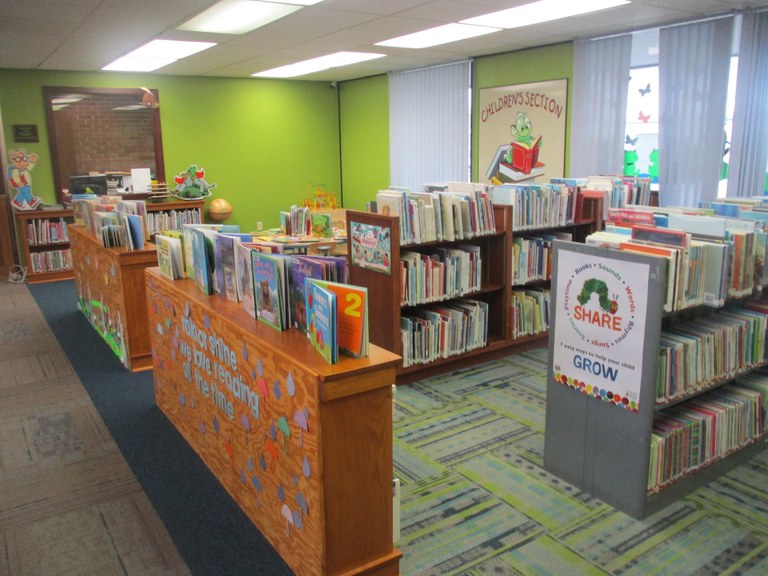 The Children's Area is bright and welcoming with shelves of books and manipulative toys designed to promote early literacy skills.